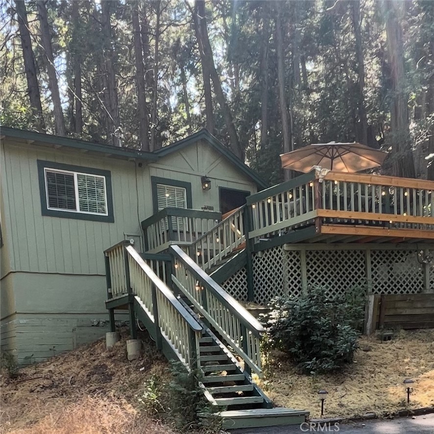 Whether you're seeking a peaceful mountain retreat or a smart investment opportunity, 23995 Scenic Dr. in Crestline offers both. This 912 sq ft home features an updated bathroom, interior laundry hookups, and a spacious deck ideal for outdoor enjoyment. Located just blocks from Lake Gregory, shopping, and dining, you'll appreciate the convenience and charm of the area. The rare lot provides parking for 6–7 vehicles—no street parking required. Additional highlights include a waterless tank and other thoughtful upgrades. Nestled in a quiet, wooded neighborhood, the property offers a tranquil setting with easy access to nearby amenities. Ideal for part-time escapes or full-time living, this home is a must-see.