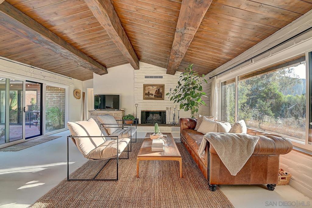 Own a rare piece of California history with this iconic 1963 Weir Brothers adobe in the peaceful Lazy H community of Pauma Valley. This 2 bed, 2 bath, 1,538 sq ft architectural gem is filled with soul—featuring authentic WWII-era Douglas fir beams, handcrafted adobe walls, a wood-burning fireplace, and rich wood ceilings that honor its mid-century roots. The remodeled kitchen is a true standout, blending modern functionality with Instagram-worthy mid-century flair—perfect for creatives, entertainers, and lovers of design. Set on a spacious 0.275-acre corner lot, the property includes a private brick patio, two large sheds, and mature landscaping with roses and fruit trees. The expansive yard is a blank canvas—ideal for garden beds, ADU potential, entertaining spaces, or simply relaxing in the peace of Pauma Valley’s natural beauty. Laundry is located in the carport area for easy access, and there’s covered parking as well. Priced to sell quickly with a low HOA of just $510 twice a year, this Weir Brothers adobe offers timeless craftsmanship, tranquil living, and architectural prestige. Minutes to the Pauma Valley Country Club and surrounded by mountain views, this is a perfect home for retirees, remote workers, and old-California dreamers. Come walk through and feel the difference—this isn’t just a home, it’s a legacy. Step into the warmth and legacy of a true Southern California treasure—this authentic 1963 Weir Brothers adobe home is a rare offering filled with historic integrity, thoughtful upgrades, and quiet countryside charm. Lovingly maintained and tastefully enhanced, this 1,538 sq ft 2-bedroom, 2-bath retreat sits on a generous 0.275-acre corner lot in the desirable Lazy H neighborhood of Pauma Valley—just minutes from the private Pauma Valley Country Club, wineries, hiking trails, and mountain views. At the heart of this home is the unmistakable craftsmanship of the Weir Brothers, renowned adobe builders whose legacy includes some of the most admired homes in Rancho Santa Fe, Poway, and Valley Center. Signature details include hand-formed adobe block construction, original Douglas fir beams salvaged from WWII barracks, wood ceilings, and a classic adobe-style fireplace, all contributing to unmatched energy efficiency and timeless architectural beauty. Inside, the home features a remodeled kitchen that perfectly balances modern upgrades with mid-century design flair—think clean lines, warm textures, and Instagram-worthy styling. The living and dining spaces are bathed in natural light, with large windows that frame the private brick patio and yard. Newer dual-pane windows were added to preserve the home’s character while enhancing insulation and efficiency. Substantial system upgrades include: • Newer HVAC system for modern cooling comfort • Newer roof for structural peace of mind • Newer water heater • Newer windows for improved energy performance Outside, the property features a large, flat open yard—an ideal blank canvas ready for your vision: add a garden, a guest casita/ADU, outdoor dining space, or simply enjoy the tranquility. Mature trees, rose bushes, and fruit trees surround the home, offering natural beauty and privacy. For those who need space and storage, two new detached sheds offer exceptional bonus space: • 10x10 Shed – Great for tools, hobbies, or art studio • 10x12 Shed – Perfect for storing equipment, seasonal decor, or workspace overflow Laundry is conveniently located in the covered carport area, which also provides protected parking and entry. The low HOA of just $510 paid twice annually ($1,020/year) helps maintain the Lazy H community charm without compromising affordability. Whether you’re a retiree seeking a peaceful escape, a remote worker looking for inspiration, or a buyer who appreciates craftsmanship and character, this home delivers. There are very few homes that offer this level of architectural significance, modern comfort, and potential for creative expansion—don...