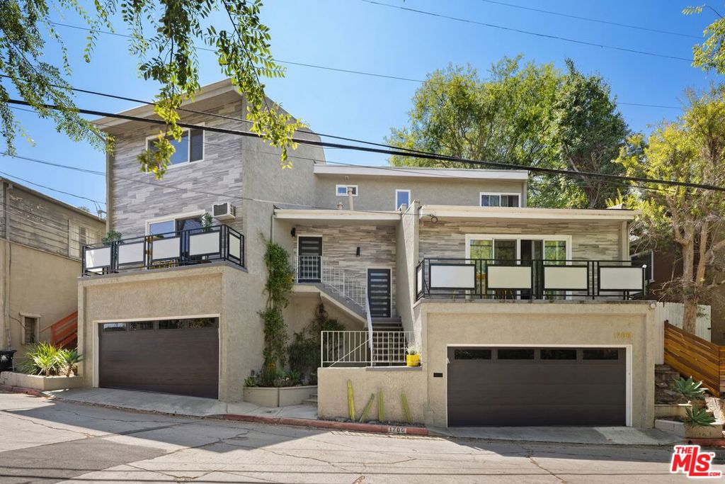 Nestled in one of the most desirable East Side neighborhoods, this newly renovated contemporary legal duplex in Silver Lake presents an exceptional opportunity for both an end-user and an investor seeking a prized property. With one unit being delivered vacant you can immediately live in one unit while generating market rate rental income from the other. Located just moments from the area's renowned eateries, boutiques, dog park, and reservoir, this home offers the ultimate in urban lifestyle living. Each side-by-side 2-bedroom, 2-bath unit has been thoughtfully updated with refinished bamboo hardwood flooring, modern kitchens and bathrooms featuring stone countertops, new windows and doors, and recessed lighting throughout. Private balconies, a seamless indoor-outdoor flow, and direct access to the rear yard create a serene setting for entertaining or quiet enjoyment. The lush terraced hillside, filled with vibrant greenery and lucky clovers, offers endless possibilities whether for sustainable gardens, creative spaces, or sunset gatherings. With two private 2-car garages and access from both streets including Easterly Terrace above this duplex provides rare convenience and versatility. From its prime positioning near LA Mill Coffee, Alimento, and Silver Lake's vibrant scene to its brand-new remodel, this property is a true gem waiting for its next discerning owner.