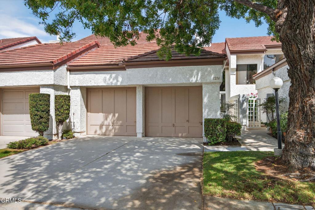 Welcome to this spacious and light-filled Mission Verde townhome, situated in the scenic Mission Oaks neighborhood of Camarillo. This well-designed home offers 1,674 sq. ft. of living space with 2 bedrooms plus a versatile bonus den on the ground floor - ideal as a home office, media room, or easily converted into a third bedroom. The open-concept living, dining, and kitchen area flows seamlessly to a generous private patio with serene views of mature trees and a fruit-bearing pomegranate tree, ideal for relaxing or entertaining. Downstairs showcases large-format tile flooring, vaulted ceilings, a stylish mosaic tile fireplace, and an updated kitchen complete with sleek countertops and stainless steel appliances. Also on the main level is a beautifully updated powder room with a custom vanity, along with a dedicated laundry room featuring built-in cabinetry for added convenience. Upstairs, each bedroom is positioned at opposite ends for maximum privacy. The primary bathroom and guest bathroom have been tastefully remodeled with walk-in travertine tile showers and designer vanities. Additional highlights include a private two-car garage, an ample driveway, and access to community RV and boat parking. Residents of Mission Verde enjoy proximity to top-rated schools and scenic greenbelt walking paths that connect directly to Mission Verde Park and a dog park.
