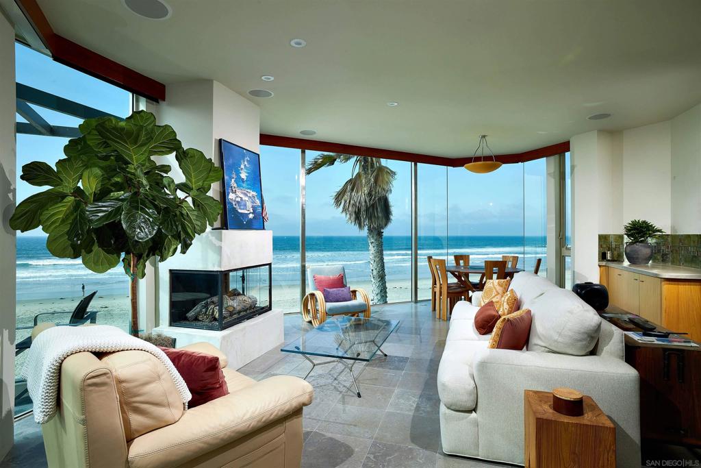 Welcome to your dream coastal retreat! This luxurious oceanfront penthouse condo offers an unparalleled living experience with breathtaking panoramic views of the Pacific Ocean. Perfectly situated on the top floor, this elegant residence combines sophisticated design, modern amenities, & the serene ambiance of seaside living. Floor-to-ceiling windows and expansive terraces provide unobstructed views of the ocean, creating a seamless indoor-outdoor living experience. The open-concept layout features a beautifully designed living & dining area, gourmet kitchen equipped with top-of-the-line appliances, custom cabinetry, & a large island. The master bedroom boasts access to the large balcony, walk-in closet, & a spa-like en-suite bathroom with a soaking tub & rain shower. Additional bedroom is generously sized, each with en-suite bathrooms & private deck. Enjoy stunning sunsets & the soothing sound of the waves from your private rooftop deck with built-in BBQ, ideal for alfresco dining & lounging. Located in the heart of Mission Beach, the condo is close to fine dining, shopping, entertainment, & outdoor activities. Experience the epitome of luxury living in this exquisite oceanfront penthouse condo, where every detail is designed to provide comfort, elegance, and an unmatched seaside lifestyle.