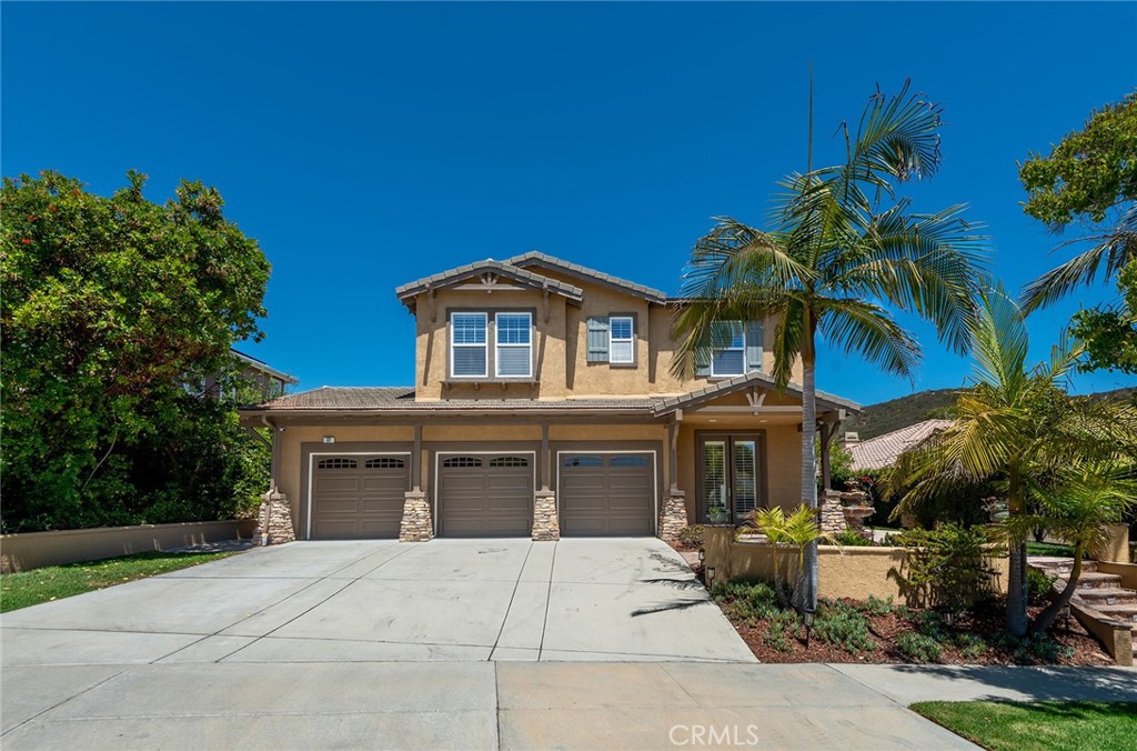 Nestled in the mountains in the Dos Vientos Community, this five bedroom, three bathroom home offers a serene setting with an abundance of natural light and lush landscaping all set on a small cul-de-sac. The open concept layout and vaulted ceilings give a striking, modern look upon entering this home with separate living, dining, and family rooms. The kitchen features stainless steel appliances, granite countertops, and a charming breakfast nook. Two bedrooms downstairs are ideal for guest accommodations and an office. Upstairs, the expansive primary suite offers a sitting area, dual vanities, soaking tub, and a large walk-in closet. Two additional generously sized bedrooms have joint access to a shared bathroom. The large upstairs laundry room is a convenient feature to this lovely home. The backyard is a private, entertainer's paradise with a beautiful lawn, pea pebble walkway and landing area, and stone hardscaping throughout the side and back yard. Enjoy the convenience of a direct access 3-car attached garage with built-in cabinetry and a Level-2 Electric Vehicle Charger ready for use. The home has been outfitted with Lutron technology that is controlled by Google Home with voice control or remote access. Nearby California Distinguished Schools, markets and shops complete this wonderful neighborhood that is ready for you to enjoy.