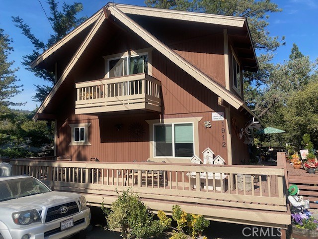 Nice home on the Greenbelt. Oversized back deck is nestled in the trees and wraps around to the front. 2 Bedrooms plus loft, 2 bathrooms. Upgraded with newer Flooring, Windows , Doors, Kitchen w/ granite counters and Appliances. Washer/Dryer hookups on lower level. New plumbing, New septic tank, New landscaping with automatic sprinklers, upstairs is an Oversized Master Suite w/ room for a seating area or office, also has a window air conditioner, Loft is also in the upper level. Glass Slider to covered back deck, You can walk down your steps to a great hiking trail up the hill or down towards the town area. Concrete Driveway for easy access, close to town and Club house.