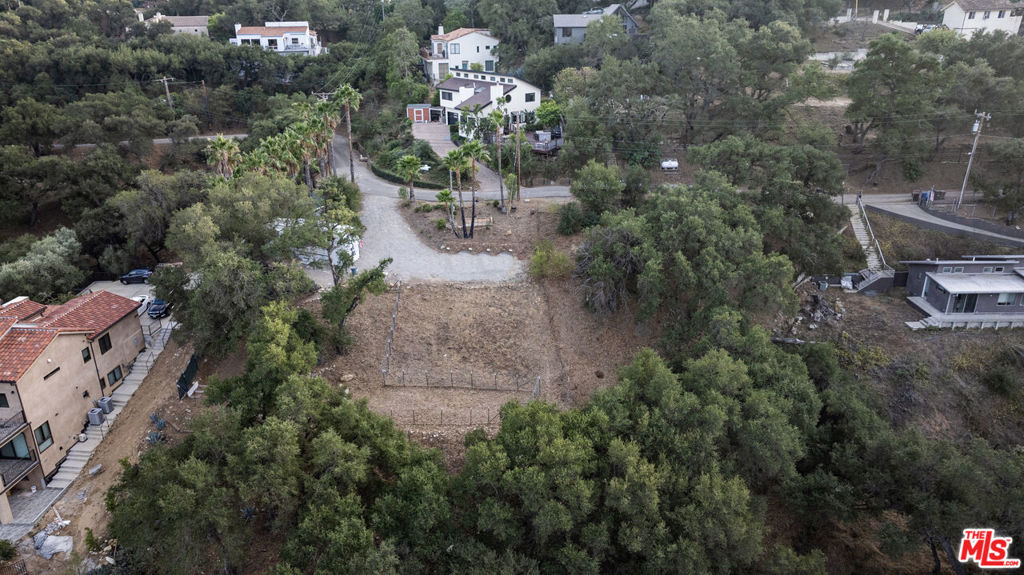 180 degree Santa Monica Mountain views from this gently sloped Corral Canyon lot. A burnout from the Woolsey Fire, this property now has approved plans and renderings, as well as LA county approvals from the Coastal Commission, septic, engineering, environmental, fire. Current owners have invested a great deal of time and money in preparation to rebuild; all of the vigorous work has been done for you! The approx. 2400 SF future home takes full advantage of its natural surroundings, with windows throughout and a spacious backyard. Purchase comes with a plumbed trailer with power and water and a shed (future space for an ADU?!). Also included are fruit trees such as lime, pear, peach, apricot. Property just minutes away from the beach, schools, local shops and restaurants... Jump right in and complete the project with a big head start already!