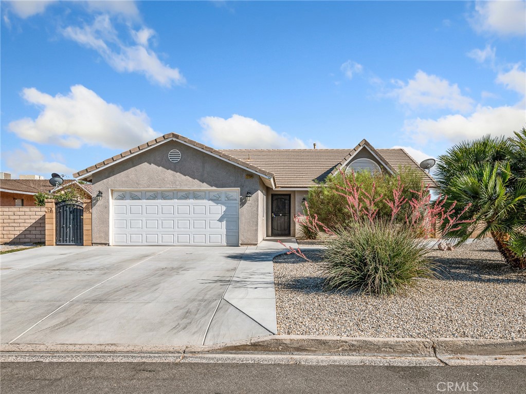 Introducing an exquisite single-story home in the sought-after Silver Lakes community of Helendale!
From the moment you arrive, you’ll be captivated by the stunning curb appeal, highlighted by meticulously designed low-maintenance landscaping. This spacious residence offers 1,836 sq ft of living space, featuring four bedrooms and three bathrooms, all set on an expansive 10,000+ sq ft lot.
Enclosed by a block wall and elegant wrought iron gates, this property offers privacy and security. Step inside to an inviting open layout that seamlessly connects the dining area to a beautifully appointed gourmet kitchen. The kitchen is a chef’s dream, boasting granite countertops, a convenient bar-top seating area, and ample cabinet and counter space for all your culinary creations. The luxurious primary suite includes dual granite vanities with generous cabinet storage, an impressive walk-in shower, and a spacious walk-in closet. Three additional generously sized bedrooms and a large laundry room provide comfort and functionality for family or guests. The backyard is an entertainer’s paradise, showcasing new rock-scaping, stamped concrete, pavers, a cozy gas fire pit, fruit trees, and an Aluma Wood covered patio. The patio is enhanced with recessed lighting and ceiling fans, creating the perfect atmosphere for outdoor gatherings. It’s also prepped for a built-in barbecue or custom BBQ island — ideal for hosting summer get-togethers. Beyond this exceptional home, the Silver Lakes community offers an unparalleled lifestyle. Enjoy two private lakes stocked with bass and trout, a 27-hole golf course, a clubhouse with a pool, spa, and sauna, plus a gym overlooking the lakes. Additional amenities include a library, RV park, and an equestrian center — truly something for everyone. Conveniently, three gas stations and various stores are within walking distance, making everyday living a breeze. Don’t miss this rare opportunity to experience resort-style living in the heart of Silver Lakes!