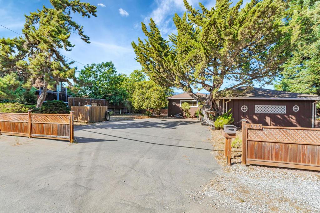 Take in the gorgeous views from both inside and out of this single-level home on a flat and sunny lot! Tucked away for a private feel, the property offers a rare mix of usable yard space, natural beauty, and everyday comfort. This light-filled home features two bedrooms and two full bathrooms plus a flexible third room - currently used as a cozy sitting space, but easily could be used as a guest room or office. The living room boasts tall vaulted ceilings, a pellet stove fireplace, and large double-pane windows that frame the incredible views. Enjoy tranquility and scenery on the redwood deck in the backyard. Multiple fenced outdoor areas are perfect for pets or kids to relax, garden, or entertain. With its own private well, exterior paint completed within the last two years, plenty of parking (including RV space), and a detached oversized two-car garage, this home truly offers it all for the lifestyle you want. Ideally located near Four Corner's Market, Spring Hills/Casserly Golf Courses, Pinto Lake + Mesa Village County Parks, a short drive to Aptos Village - plus quick access to HWY 1 for an easy drive to Carmel/Monterey. Also, close to Santa Cruz Beaches! This home is ready for it's next chapter, make it yours!