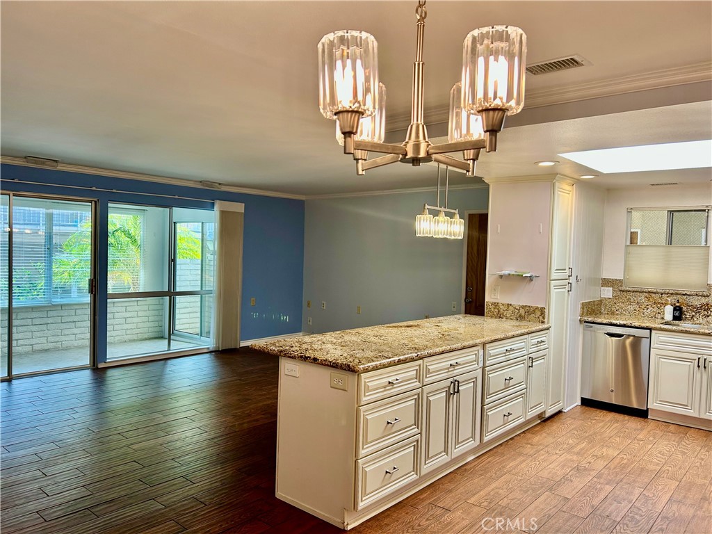 Laguna Woods Village for senior 55+. Welcome to this serene Casa Linda unit, boasting 2 bedrooms and 2 bathrooms. This NO ONE ABOVE OR BELOW customized home is a nature lover's dream, ideally situated near the top of the Aliso Creek trail, just steps away from stunning wildlife views and picturesque scenery. This updated unit features an enclosed patio, central air conditioning, new flooring, and a beautiful kitchen equipped with a built-in microwave, new refrigerator, new stove top, and updated fixtures. The convenience extends to an in-unit washer and dryer. Covered parking is conveniently located just steps from the front door, providing ample storage and an electrical plug for your electric car or golf cart. Gate 4 offers easy access to a variety of shops, restaurants, and grocery stores. Additionally, the famous Laguna Woods Performing Arts Center is within walking distance, offering concerts and movies at reasonable prices, along with a host of other community amenities. Your guests will appreciate the abundance of visitor parking available. Don't miss the opportunity to move into this exceptional unit! Carport # 471 - 11.