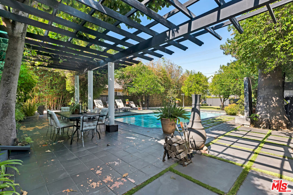 Welcome to your own private retreat in a prime Tarzana location! This beautifully gated property features a lush outdoor setting with mature fruit trees, a sparkling pool, and a generous grassy areaperfect for both relaxation and entertaining. The main house offers approximately 1,600 sq ft with 3 bedrooms and 2 bathrooms, including a spacious primary suite with a large walk-in closet and an upgraded bathroom. The open-concept floor plan seamlessly connects the kitchen, dining, and family rooms for comfortable everyday living. A brand-new AC system ensures year-round comfort. Toward the back of the property, you'll find a tranquil yard with a soothing water feature and additional storage. The detached guest house (ADU) is approximately 500 sq ft and includes 1 bedroom and 1 bathroomideal for guests, extended family, or rental income. With a combined total of 2,100 sq ft, this home is perfectly located near hiking trails, top-rated schools, golf courses, shopping, dining, and freeway .SELLER HAS 700.000 ASSUMABLE LOAN AT 3.6% INTEREST