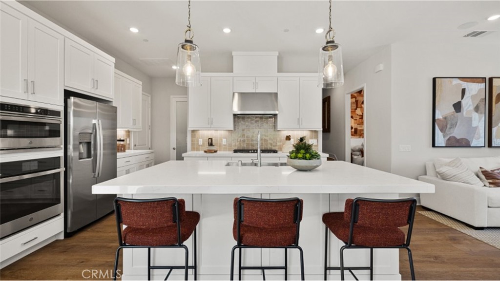 THIS HOME HAS DESIGNER SELECTED FLOORING THROUGH OUT. This new two-story home boasts a modern and spacious layout with ample room to live and grow. An inviting open-concept floorplan with access to a covered patio can be found off the entry, with a convenient bedroom and full bathroom nestled into a corner. Upstairs, four bedrooms surround a versatile loft, including the luxurious owner’s suite with a generous walk-in closet and en-suite bathroom. ONE OF THE FOUR BEDROOMS UP HAS A SEPARATE STAIRCASE TO A PRIVATE SUITE WITH A SMALL LIVING ROOM, BEVERAGE REFRIGERATOR AND STCKED WASHER DRYER!!
