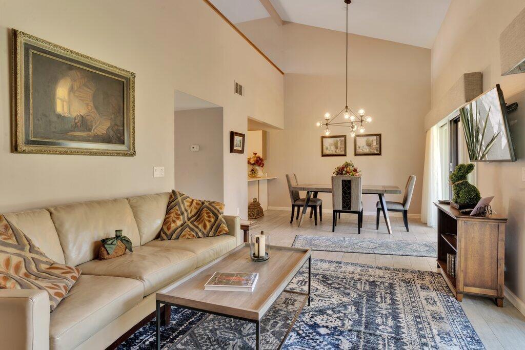 Serene Desert Retreat in Park Palms! Step into this charming Palm Desert oasis, where the tranquil ambiance of Park Palms welcomes you with lush landscaping, swaying palms, and vibrant bougainvillea. This well-maintained two-bedroom, two-bath condo offers a thoughtfully designed layout, perfect for both full-time residents and seasonal visitors looking for a peaceful retreat. As you enter, the two-story ceiling in the living and dining areas create an airy and inviting space, bathed in natural light. The living room's cozy fireplace adds warmth and charm, while sliding doors lead to a spacious east-facing patio overlooking a meandering stream--a serene setting to enjoy your morning coffee. The main-floor primary suite offers privacy and convenience, with an en-suite bath and direct access to the patio. Upstairs, the second suite features a walk-in closet and a dual-access bath, making it a perfect retreat for guests. The loft area provides incredible versatility--ideal as a family room, home office, or even an additional sleeping space. Located at the end of the street, just steps from the main pool--simply walk out from the back of the condo. Beyond the home itself, Park Palms offers resort-style amenities, including three community pools and spas, a clubhouse with a fitness center and sauna, tennis and pickleball courts, and a charming putting green. The gated courtyard entrance and two-car garage provide added privacy and convenience. Located in a prime Palm Desert location, this home truly embodies desert living at its finest, offering a blend of comfort, natural beauty, and an active lifestyle--all within minutes of top dining, shopping, and golf courses. Come experience it for yourself!