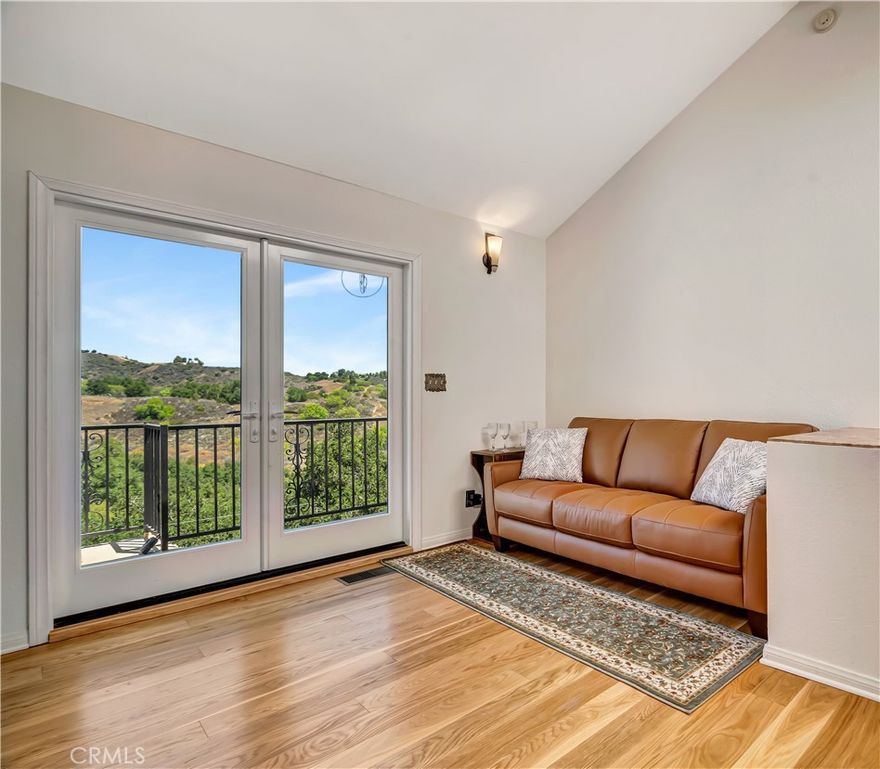 Bright and spacious two bedroom + office, two bathroom retreat in the serene canyon woodlands of this sparsely populated coastal community. Relisting following upgrades, including new oak and acacia hardwood floors, most appliances and paint. Actual square footage is 1832, including the lower level, all in the approved plans. Built to last with expertly engineered caissons for earthquake resistance, interior sprinklers and double paned windows for fire resistance, and a new, wind resistant architectural shingle roof. Oak cabinetry, granite counters and artisanal fixtures. Savor the quiet as you relax in the Japanese ofuro spa, cozy and snug by the wood/gas fireplace, gazing at the night skyscape, on a deck overlooking the wildlife corridor and hiking trails, or sprawling in the breezy lower unit nestled in the oaks.  Ten minutes to the 101 and all the conveniences of the valley, and fifteen minutes winding through the canyon to the beach, with Santa Monica to the left and Malibu to the right. Or stay local for a meal, farmers market or galleries. Upper level is a complete living space with abundant natural light from three skylights. Built-ins include a granite/oak desk, eight-foot display case and entertainment center. New French doors are an additional guest entry. Midlevel lends itself to a home office, music room or entertaining, with a formal foyer and entry closet. The spacious lower level can be separated for a co-buyer, out of town guests, artist's studio, rec room, with the largest deck for outdoor enjoyment, 110 square feet of storage and a wine cellar. Garage has a direct entry to the foyer, a gym area inside the bay window, and a convenient washer/dryer, with two additional parking spaces on site. The natural hillside terrain makes this a lock-and-go for seasonal occupants or business in Los Angeles.