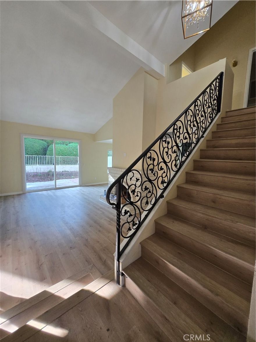 Welcome home to this stunning, fully remodeled 2-bedroom townhome with a versatile family room that can serve as a 3rd bedroom, located in the highly desirable Malvern Creek community of Fullerton — known for its top-rated schools and convenient location. Step inside to find a spacious living area featuring a cozy fireplace and laminate wood flooring throughout. The modern kitchen has been completely updated with new countertops, cabinetry, stove, and micro-hood, and opens to a bright dining area perfect for family meals. Enjoy the comfort of a powder room downstairs, along with direct access to a finished 2-car garage featuring washer and dryer hookups and a newer water heater. Upstairs, the primary suite offers a large walk-in closet and a luxurious en suite bathroom with dual sinks, a private soaking tub, and a separate shower enclosure. The second bathroom includes a stand-up shower and updated finishes throughout. Relax or entertain in your private backyard space, ideal for outdoor dining or gardening. This two-story home shares only one common wall, providing exceptional privacy and peace. Residents enjoy access to the community pool and well-maintained grounds, making this the perfect blend of comfort, style, and convenience.