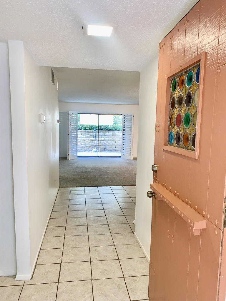 Great opportunity to buy a 2/2 ground level end unit in Central PS on fee land. Newly painted. Upgraded HVAC in 2020 per previous seller .Living room and back bedroom open to private back patio area. just minutes to the heart of downtown. HOA includes common areas, water, trash, cable, internet. Gated community features 3 pools, lighted tennis/pickle ball courts 2 spas, clubhouse, fitness