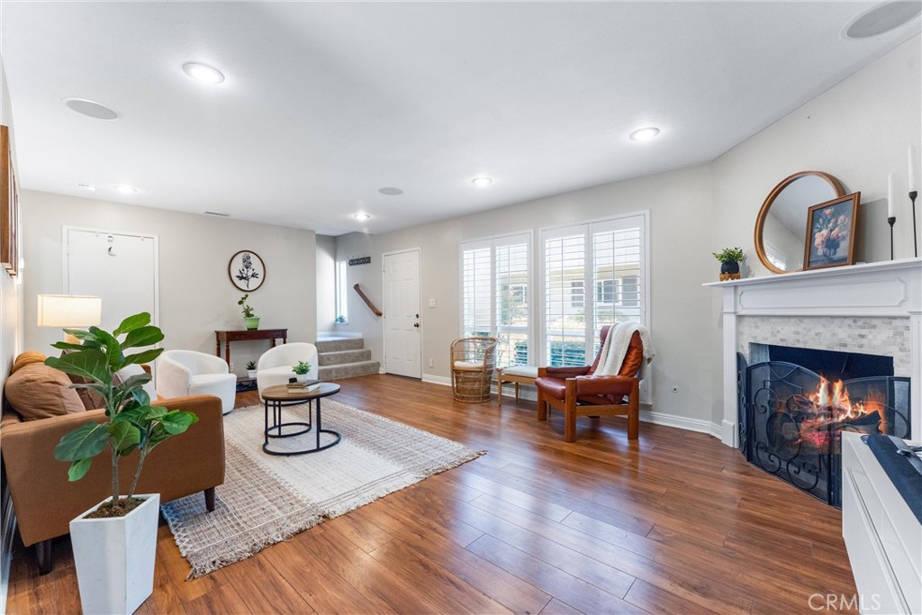 Looking for your first home in Orange County that’s affordable, spacious, and move-in ready? Welcome to 1121 E 1st Street—where charm, comfort, and location come together for the lowest price per square foot for any two-bedroom in Tustin! Even better? The seller is willing to cover the one-time HOA assessment for roof and pool upgrades with the right offer, giving your budget a much-needed break. Step inside this light-filled townhome and you’ll instantly feel at home. The living room is wide open and inviting—perfect for game nights, quiet weekends, or movie marathons by the fireplace. The layout flows easily into the dining area and an updated kitchen that’s ready for your favorite recipes, with white shaker cabinets, granite countertops, and stainless steel appliances. You’ll also enjoy in-unit laundry (no more trips to the laundromat!) and a private fenced patio—ideal for morning coffee, a garden, or evening hangs with friends. Upstairs, you’ll find two truly spacious bedrooms, both freshly painted with brand-new carpet and tons of closet space. The full bath includes dual sinks and a tiled tub/shower combo, while a half bath downstairs adds everyday convenience. It’s a smart layout that feels even bigger than the square footage. You’ll also love the community’s vibe, landscaped paths, and the pool (currently being upgraded). Your assigned carport is close by, and when you're ready to venture out, Trader Joe’s, Tustin Brewery, and a bunch of grocery stores, restaurants, and shops are just a few blocks away. Located in the Tustin Unified School District with easy access to the 5 and 55 freeways, this is the perfect spot to plant roots. Whether you're starting your homeownership journey or just looking for a turnkey space in a prime location, this townhome checks all the boxes—space, updates, value, and community. Don't miss this one!