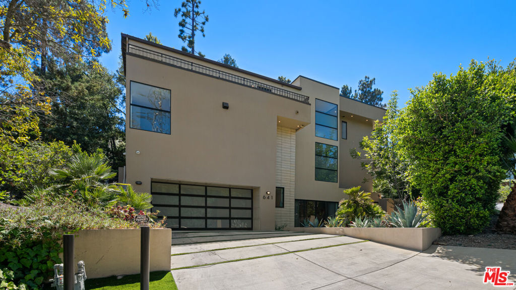 Ideal for a 1031 exchange, with a healthy lease in place through October 3, 2026, this striking Brentwood residence offers an exceptional investment opportunity. Privately nestled in a sought-after neighborhood, the home showcases inspired architectural design across three expansive levels, each with open living areas, inviting fireplaces, and effortless access to the outdoors. The main floor opens to an impressive great room that blends a designer chef's kitchen, a stylish dining space with a dramatic wine wall, and a warm living area centered around a fireplace. Large glass doors extend the living space to a refined outdoor dining and entertaining patio. The upper level hosts the serene primary suite with a spa-style bath, along with two additional en suite bedrooms and a comfortable family lounge. The lower level is tailored for leisure and entertainment, featuring a sleek bar, a media-ready family room with fireplace, a private screening room, and two more bedroom suites-one perfectly suited for a home office. With its seamless indoor-outdoor connection, exceptional privacy, and sophisticated design, this home offers both an elevated lifestyle and enduring appeal.
