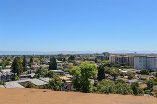Welcome to Top of the Mounds, one of San Mateo's premier luxury condominium communities. This completely remodeled condo with fantastic bay views is turn key and ready to be moved into. No one has lived in the unit since the luxury renovation. The kitchen features Wolf double oven and stove top, Bosch refrigerator, granite counters, new ample cabinetry and all new amenities to make your cooking experience a delight. The new hall bath has tiled floors, marble stall shower and all new fixtures. The master suite has great bay views as do all the rooms and master bath has marble stall shower with frameless glass enclosure, Hansgrohe shower controls and separate tub. There are to many amenities to mention including hardwood floors in all the living areas and hall ways except the bedrooms which have plush carpeting. This unit also has a semi private spacious 2 car garage with extra storage.