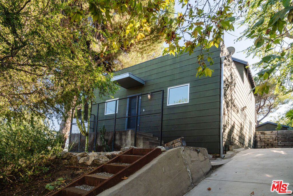 Classic California modern in the hills of Silver Lake available now for long term unfurnished lease. Perched above the reservoir with views of the neighboring hillsides, this modern farmhouse re-envisioned in 2006 by architect Barbara Bestor offers comfortable living with many creative touches. The two-story home features an open main living space on the first floor with large windows allowing light to fill the space all day long. A stylish kitchen, dining area and living room along with two bedrooms and one bath complete the first floor. The top level is the primary suite with two decks and en suite bathroom with free-standing tub and walk-in shower. Located on a spacious corner lot with lush mature vegetation and large outdoor spaces perfect for entertaining or allowing the pets or kids to run free. A rear detached studio is a great bonus space for guests or working from home with its vintage beamed ceiling and full bathroom. Additional spaces include storage/work space under the house as well as a large attic. Off street driveway parking for two tandem cars as well as easy street parking. Dream location just moments from the Silver Lake reservoir, meadow and all the best east side shops, restaurants, and more.