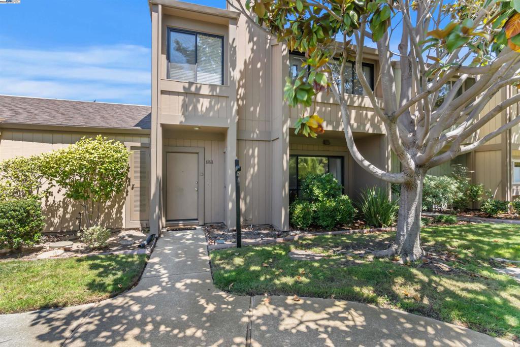 This beautiful two story townhouse has been updated with new paint, new flooring and an updated kitchen. The living and dining rooms have a wonderful fireplace and look over the large grass areas leading up to the front door. In back, there is a private patio and detached two car garage. The neighborhood is surrounded by parks and is very near to shopping and services. Do not miss this opportunity.