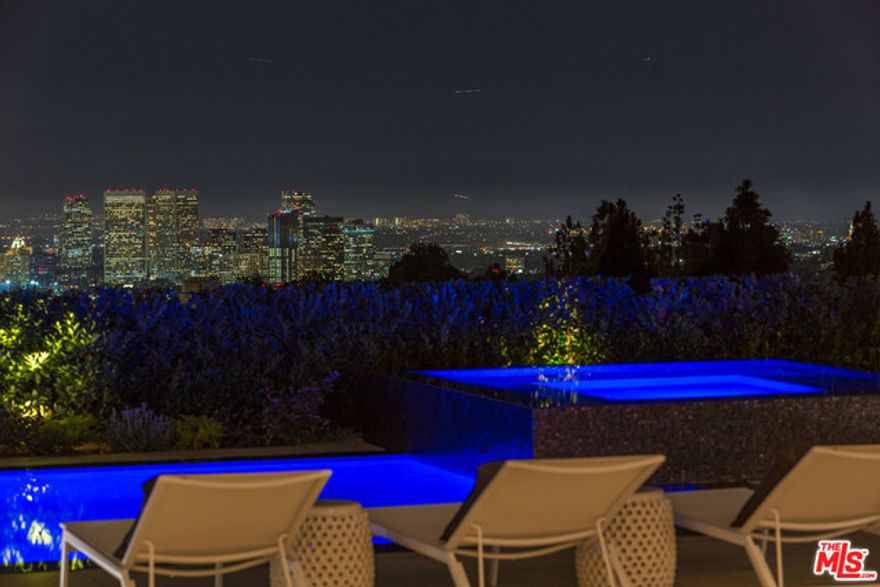 Elvis, Sinatra, Dean Martin: there's good reason that the world's style masters chose to call Trousdale home. This bespoke compound on an oversized lot featuring five luxury suites set upon the ultimate indoor-outdoor floor plan exudes sophisticated elegance in both its striking architecture, by world renowned Michael Marquez, and its exquisite details. The developer, master of chic, Clive Robertson, scoured each corner of the globe to source every minutiae: from the Tibetan Leathered Monk Stone to the lavish Antarctic Stingray media room, to the Travertine that adorns the facade, sourced from the Bagni di Tivoli quarry that built the Roman Coliseum. Beautifully complimenting these ancient extravagances is the absolute cutting edge of technology: biometric access to a private room, a 360 degree turntable and Crestron Smart Home System - even James Bond would be awe stricken. This home sets a new standard in interior design; truly a masterpiece, a grand symphony of the finest materials.