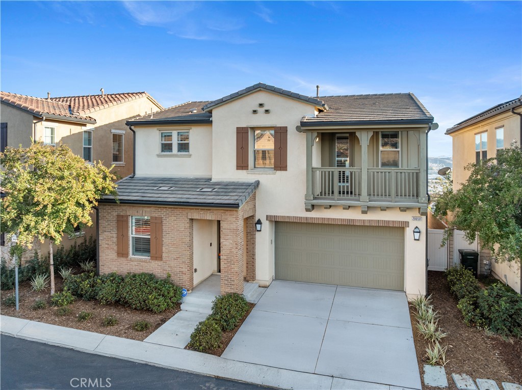 Beautiful Five Knolls Home – Spacious 4-Bedroom with Bed and Bath Downstairs and Resort-Style Amenities. Welcome to this stunning Five Knolls home offering over 2,200 SQFT of open living space with a highly desirable floorplan. This light and bright residence features a downstairs bedroom with a full bathroom and walk-in shower, perfect for guests or multi-generational living. The large living room seamlessly flows into the eat-in kitchen, which boasts a center island, stainless steel appliances, granite counters, and a walk-in pantry—ideal for entertaining. Upstairs, you’ll find a spacious primary suite with gorgeous views, a spa-like ensuite bathroom with dual sinks, a large soaking tub, glass-enclosed walk-in shower, and a huge walk-in closet. The upper level also includes a huge laundry room with folding station and storage, two additional bedrooms (one with a private balcony with views), and a shared bathroom with dual sinks. Interior upgrades include shutters, ceiling fans, and designer touches throughout. Step outside to enjoy your private backyard retreat with views, custom pavers, stone planters, lush landscaping, fruit trees and a built-in outdoor cooking station. The 2-car attached garage with epoxy flooring. Five Knolls is a community that offers a Resort Style Clubhouse "The Club", Security Patrol, Pool and Spa, Playground, BBQ areas, Half Court Basketball, City park with Dog Park, Butterfly Knoll and much more. It is also located near the famous Santa Clarita Paseos, Hiking Trails, Biking Trails and a short distance to shopping centers with restaurants, Walmart, Sam's Club, and LA Fitness. Don’t miss the opportunity to own this exceptional home in one of Santa Clarita’s most desirable neighborhoods!