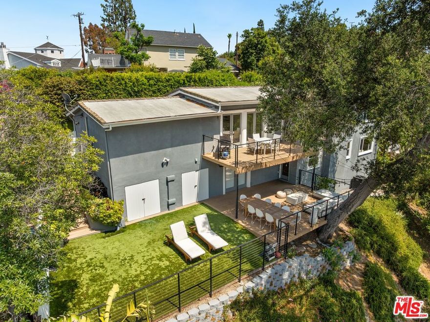 This exquisitely remodeled two-story home is perched in the tranquil hills of Sherman Oaks, tucked away on a private shared driveway that ensures both privacy and serenity. Offering 3 bedrooms and 4 bathrooms, this stunning residence combines modern luxury with breathtaking tree-top and city-light views.Step inside, and you'll be welcomed by abundant natural light streaming through expansive windows, highlighting the warm tones of the new hardwood floors. The open-concept floor plan effortlessly flows from the foyer into the inviting living room, where a striking fireplace serves as a focal point. Adjacent to the living room, the dining area opens onto a brand-new composite deck with sleek railings, providing a serene setting to enjoy peaceful views of the Valleys.The remodeled kitchen is a masterpiece, boasting high-end finishes, brand-new appliances, and a built-in breakfast nook, ideal for cozy family meals. Upstairs, the primary suite is a sanctuary of sophistication, accessed through a grand archway. The ensuite bath impresses with dual vanities, a soaking tub, a walk-in shower, and a spacious walk-in closet.Downstairs, a large bonus room offers flexible space for a playroom, game room, or family lounge, complemented by newly installed wallpaper that adds a stylish touch. This level also includes two generously sized ensuite bedrooms, one of which features a newly remodeled bathroom.With  bedrooms provide access to the expansive backyard, where new turf and vibrant landscaping with succulents, fruit trees, and other greenery create a private oasis.The home has been thoughtfully updated with a host of modern enhancements, including a new AC unit, a whole-house water filtration system, and Nest smart systems for added convenience. Additional updates include redesigned front entry tiles, a relocated staircase for a more open layout, and a custom garage cabinet system.This turn-key home seamlessly blends modern elegance with comfort, offering a retreat-like atmosphere while being just moments away from the best of Sherman Oaks. Don't miss this opportunity to own your dream home!