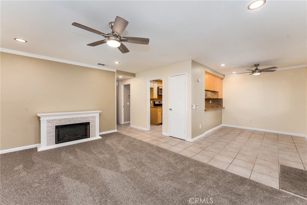 Discover a beautifully renovated condominium, nestled within a peaceful, secured, gated community, conveniently located near the 60/91/215 freeways, and just about one mile from the renowned UC Riverside ranked #19 among Western colleges, published by Forbes. Step into this stunning upper-level condominium, thoughtfully upgraded with freshly painted walls making it feel brand new, newly installed recessed lighting brightening up the entire home, and a modern electric fireplace wrapped around with custom backsplash serving as a striking focal point—elevating the entire living space. The kitchen is thoughtfully designed with granite countertops, newer appliances, and abundant cabinetry to keep everything within reach. Just down the hall, you’ll find a well-appointed laundry area with hookups for a gas or electric washer and dryer, complete with added shelving making organization simple and efficient. The primary bedroom boasts a spacious walk-in closet with built-in shelving, a sleek, modern ceiling fan with a stand-up shower with each bedroom reflecting the home’s cohesive aesthetic with updated new elegant fans. The secondary bathroom features a freshly reglazed bathtub, giving you peace of mind and a clean, refreshed feel. Step out onto your private balcony, an ideal space for enjoying your morning coffee or hosting weekend barbecues, enhanced with a pergola that offers relaxing, shaded comfort year-round. Just a stone throws away from the pool, this unit includes a 2-car garage with extra storage space, a private parking space right next to the unit, and the rare luxury of having no neighbors on either side offering privacy and quiet. Residents enjoy the endless amount of guest parking, a sparkling, well-maintained pool, a clubhouse, and the comfort of a pet-friendly community. This turnkey condo offers the perfect blend of comfort, style, and convenience—an exceptional opportunity you don’t want to miss.