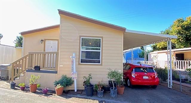 This beautiful 2015 home has it all. To begin it has approx. 960 Sq. Ft. , 3 beds, and 2 baths. It also comes with energy-efficient double pane windows. As you enter you will notice the cozy living room with easy to care for Pergo flooring and a ceiling fan with lights. Then an inviting dining room area with a lovely chandelier style light fixture. The kitchen provides plenty of cabinet space and is well equipped with a window air conditioning unit, stainless steel refrigerator, stove, oven, and dishwasher. The guest bedrooms both have ceiling fans with lights and Pergo flooring. The guest bathroom is complete with a shower and tub. The master bedroom includes a walk-in closet. The master bathroom has an additional closet and also comes with a shower and tub. A laundry room is included with a washer and dryer. Parking is a breeze with a spacious carport with room for 3 cars. It situated in a convenient friendly neighborhood, near shopping, dining, and more! Serial #009000HA001236 B/A
