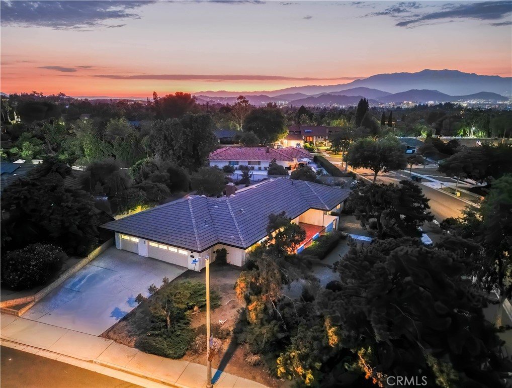 This Prestigious Canyon Crest mid-century classic home situated on an elevated corner offers privacy and a view of the surrounding mountains and City Lights. This single-story home include a Hardwood Flooring with 4" Colonial Baseboards throughout with Carpet in Bedrooms, Master bedroom with Walk-in Closet, Vanity Dressing area with Sink, Wide-Blade Shutters, Master Bath with Bidet, Walk-in Shower and Door to Exterior. Kitchen with Eating area and large Pantry, Wolf gas range and Slider to Tiled Patio. Home includes Solar System, Security Camera System, Vinyl Thermal Windows throughout & 2 Sliders, 2 see-through Fireplaces, 6 Ceiling Fans, Laundry room, Large Den with Slider, 3-Car Garage with Cabinets, Attic Ladder and Fan, 8 Fluorescents, Wash Basin and Golf Cart Hook-Up, Fenced Dog Run with Doggie Door adjacent to the back yard, several Citrus Trees, Bubbling Fountain, Irrigation, Security Lights and More. Canyon Crest Country Club with Golf Course, Tennis, Swimming and Social Activities.