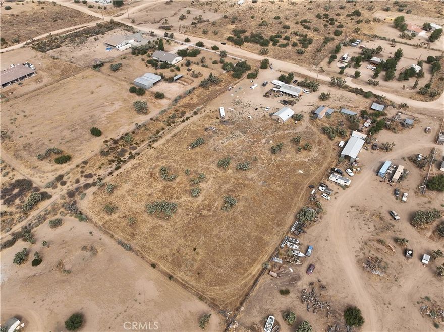 Discover the potential of this 5-acre property on the desirable south side of Phelan. Fully fenced and offering plenty of space, this property is ideal for those seeking privacy, room to expand, or the option to build an additional home.



A large workshop measuring approximately 40x50 provides endless possibilities for storage, hobbies, or projects. One container is also included for added storage.



The property includes a 3-bedroom, 2-bathroom mobile home with a spacious floor plan, ready for updating and customization. The kitchen features generous cabinet and counter space, creating a functional hub for everyday living.



Located within the highly regarded Snowline School District, this property combines convenience and opportunity. With the potential to split the lot, this is a rare chance to create a family compound or investment for the future.