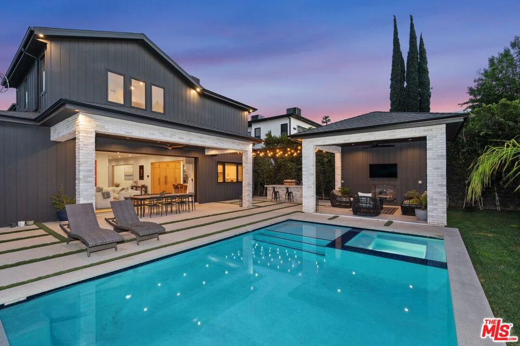 Experience luxury living in this stunning approx. 4,100 sqft home, built in 2022 and ideally located in the heart of Encino, just steps from Ventura Blvd's premier shopping and dining, with easy access to the 101 and 405 freeways.This 5-bed, 5.5-bath architectural masterpiece boasts soaring 10' ceilings, elegant chandeliers, a Control4 smart home system, and a glass-enclosed wine display under the staircase. The chef's kitchen is a showstopper, featuring a massive center island with seating and prep sink, Thermador appliances, a 6-burner gas range with griddle, double oven, 48" refrigerator/freezer, custom cabinetry, and a walk-in pantry. The spacious family room offers a gas fireplace, built-in entertainment center, and 18' pocket doors that open seamlessly to an entertainer's dream backyard.Enjoy a sparkling pool, spa, built-in BBQ, covered patio, outdoor fireplace, and lush landscaping, including mature ficus trees for privacy, palm trees, and lemon and lime trees.The luxurious primary suite features vaulted ceilings, a custom walk-in closet, and a spa-like bath with dual showers, dual sinks, and a freestanding soaking tub. Additional highlights include a custom home theater with state-of-the-art sound, an ADT security system, 8 HD security cameras, an indoor/outdoor surround sound system, an upstairs laundry room, and a two-car garage. Don't miss the chance to live in this exceptional home in a prime location. schedule your private tour today!