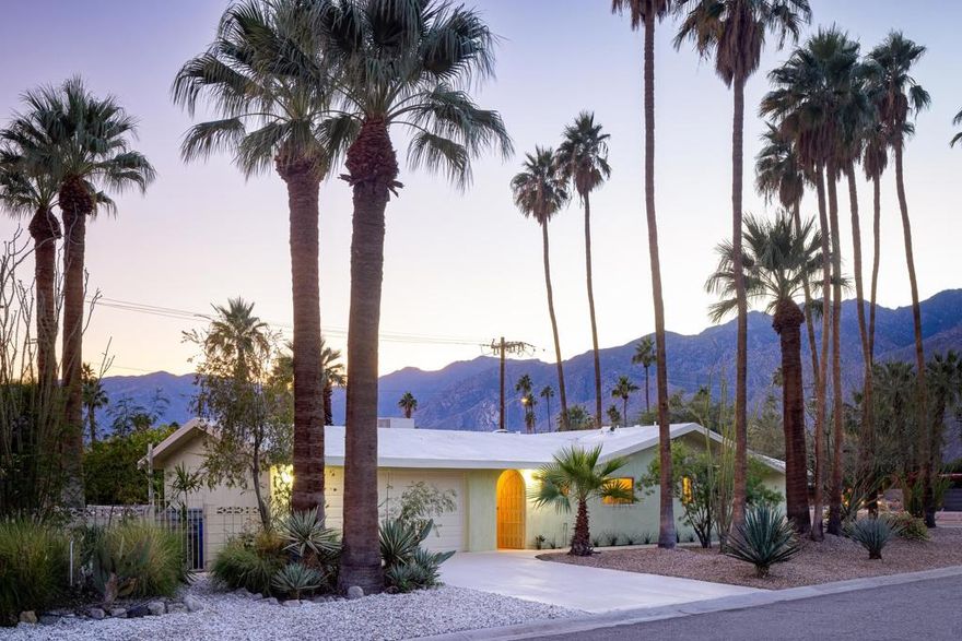 Step into this beautifully reimagined 3 bedroom, 4 bathroom home located in the heart of Palm Springs in the highly sought after neighborhood of Sunmor. Nestled on the corner of Julian and Farrell, the property's entrance and driveway are on the quieter side of Julian. Inspired by classic 1970s design, this home boasts warm organic materials, custom craftsmanship, and curated character throughout. The home was thoughtfully designed and renovated by an interior designer and the sale includes all furnishings. Upon entering, the main living area is filled with natural light and features an exquisite stone fireplace. The kitchen and living space flow seamlessly together, highlighted by a white oak banquette with a built-in dry bar and brand new cabinetry with marble countertops and new appliances. The primary suite includes a custom floating vanity, a built-in headboard with integrated nightstands, and a large walk-in closet. This fully furnished home offers vintage designer furnishings, selected to enhance the architecture while blending seamlessly with the home's 1970s inspired aesthetic. Thoughtful design is evident in the home's layout, with three well-proportioned bedrooms providing flexible space for guests, a home office, or creative studio. Quality upgrades throughout include new windows, solid wood French doors, new flooring, custom tile showers, updated fixtures, new appliances, and new hardware. Outdoors, solid wood tongue and groove patio ceilings complement custom wrought iron gates, a Bocce court, and an organic landscape with mature trees and sculptural cacti. The backyard is oriented to maximize sunlight and features a pool positioned to take in sweeping mountain views. The oversized lot has adequate space for ADU or guest house.This home offers a timeless Palm Springs experience in one of the city's most beloved neighborhoods.