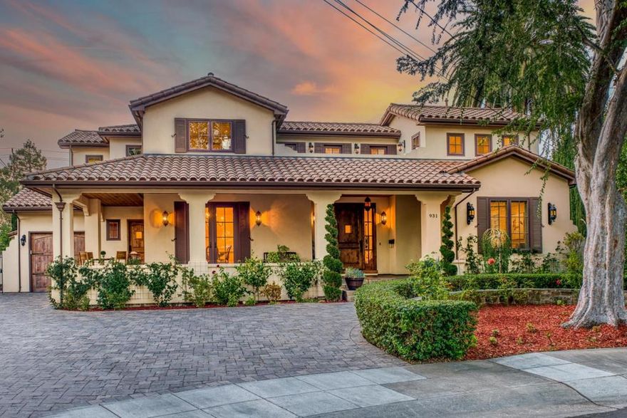 CUSTOM MEDITERRANEAN ON CUL-DE-SAC | Flanked by wide covered verandas, this Mediterranean luxury residence on an oversized cul-de-sac lot embraces lavish yet comfortable living. Abundant millwork, hardwood floors, and custom details add elegance throughout. Formal living and dining rooms are designed for entertaining, while a great room with jaw-dropping island kitchen and breakfast nook provides plenty of leisure space. Gourmet amenities include dazzling stone countertops, extensive bar seating, and catering-grade appliances. Upstairs await two secondary suites, a large patio, and gorgeous primary suite with dual custom closets and dual luxury baths. Includes a ground-level guest suite and office/fifth bedroom. Multiple French doors open to a large, private backyard featuring a studio, perfect for an office or playroom. Stroll to Seale Park and Midtown Shopping Center. Near excellent schools like Palo Verde Elementary, JLS Middle, and Palo Alto High (buyer to verify).