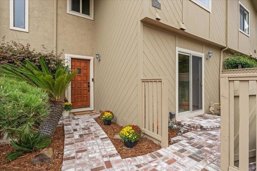 Exquisite Seascape Townhome Nestled in the coveted Seascape community, this elegant three-bedroom, two-and-a-half bath residence seamlessly blends sophistication with coastal charm. A custom brick patio and walkway define the entrance, setting the tone for the style and quality found within. Thoughtfully appointed with designer finishes, the home is oriented to capture serene views of the lush greenbelt. The expansive living and dining area flows effortlessly to a generous entertainment deck, while the private primary suite offers a tranquil retreat with vaulted ceilings, its own secluded deck, and a spa-inspired bath featuring a custom-tiled walk-in shower. The secondary bath is equally refined, complete with a tub-shower combination. Additional highlights include an oversized laundry and storage room, and a two-car garage with a finished floor and exceptional storage capacity. All within strolling distance to Seascape Village, boutique shopping, acclaimed restaurants, and the Seascape Tennis Clubthis is luxury coastal living at its finest.