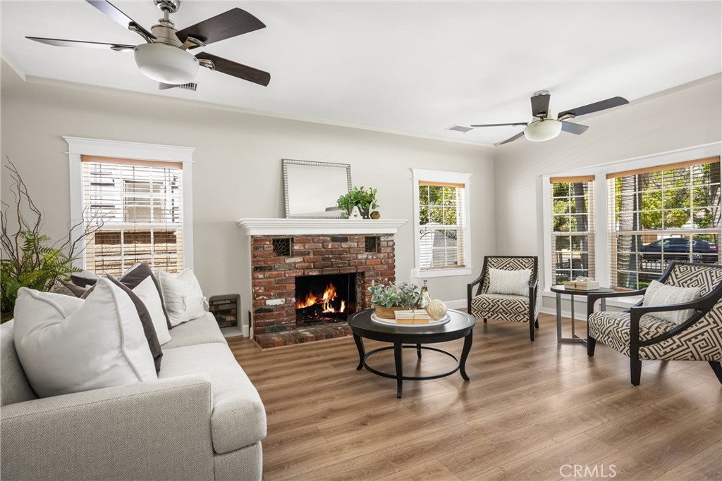 Charming 1930s bungalow located in the heart of Santa Ana’s historic Washington Square neighborhood! This thoughtfully updated 2-bedroom, 1-bath home offers 1,256 sq ft of living space and blends timeless character with today’s modern comforts. Original built-ins and classic architectural details celebrate the home’s vintage roots, while upgraded vinyl plank flooring and quartz kitchen countertops provide style and durability. The inviting living room is filled with natural light, flowing seamlessly into a formal dining area—perfect for everyday living or entertaining. The updated kitchen offers clean lines, white cabinetry, and ample prep space. Situated on a generous 6,693 sq ft corner lot, the outdoor space features mature landscaping, a grassy yard, and a covered patio ideal for relaxing or hosting guests. A detached garage provides additional storage and off-street parking. Located just minutes from downtown Santa Ana, the Artist Village, and 4th Street Market. This is a rare opportunity to own a move-in-ready home in one of Santa Ana’s most established and charming neighborhoods.