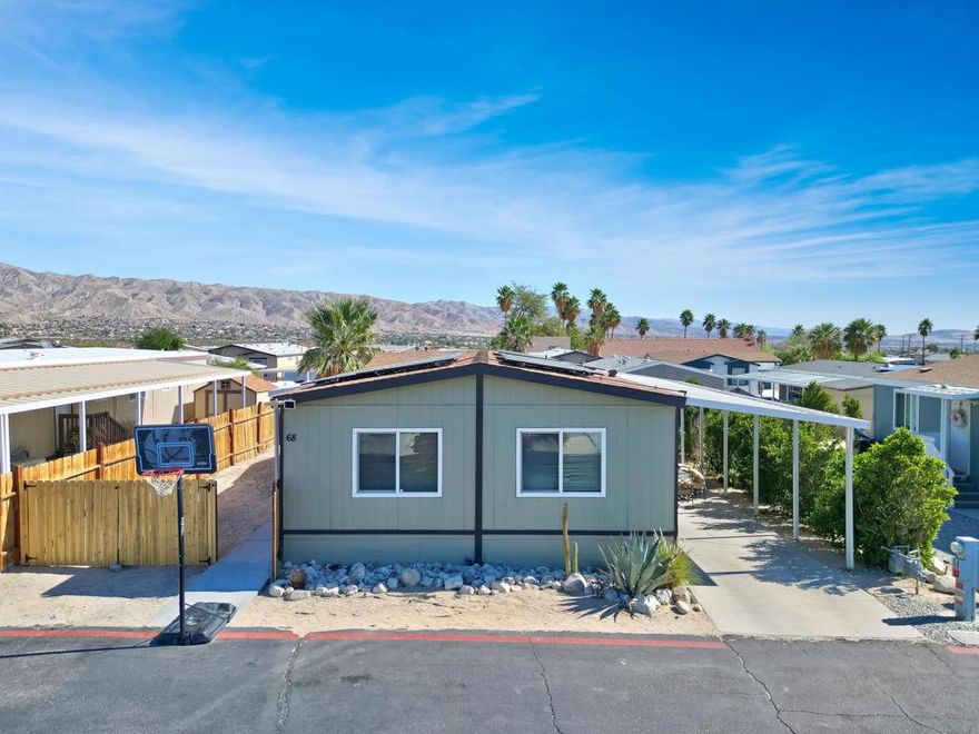 Energy Efficiency, Location, Affordability: Welcome to #68 at the all ages community of Palm View Estates. This cozy 3 bed 2 bath manufactured home features an open concept living /dining area, upgraded kitchen with quartz countertops. This property also comes with a solar lease and offers low energy cost of $175 per month! Step outside to the covered patio and low-maintenance yard perfect for relaxing evenings under starry skies. Includes carport parking and roomy storage shed. Just minutes to natural hot springs, walking trails, the I-10 Freeway, Palm Springs and other desert destinations. This is your chance to own a desert home at a low price!