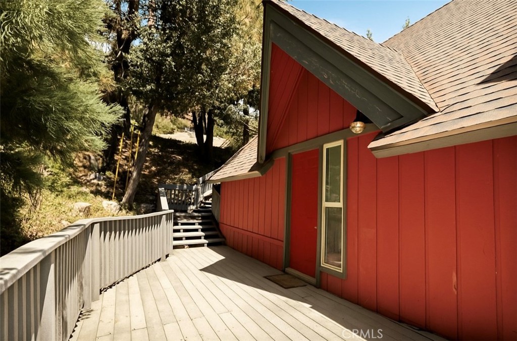 A LIGHT AND BRIGHT LAKE ARROWHEAD SANCTUARY nestled amidst the tranquil pines and perched with a peek a boo lake view and LAKE RIGHTS. This lovingly maintained Lake Arrowhead retreat combines timeless charm with fresh modern touches. Built in 1977, this three-bedroom, three-bathroom single-family home offers a warm and inviting sanctuary just steps away from nature’s. Start each day with serene vistas, as sunlight filters through the trees to reveal glimpses of the tranquil lake below. Newly painted interior and exterior, complemented by new carpet and areas of new flooring set the stage for a bright and inviting ambiance. A refreshed primary bedroom suite invites crisp mornings and tranquil evenings and serves as a peaceful sanctuary. The outdoor space offers endless opportunities for relaxation, entertaining, and soaking in scenic views on the expansive upper and lower decking providing the perfect space for sunrise coffees, alfresco dining, or entertaining under the stars, all while embracing the peaceful surroundings. Tucked away yet conveniently accessible via dual access points, the property offers seclusion without sacrificing accessibility, which is ideal for guests or family. This turn key home welcomes you immediately, while still offering creative opportunities to personalize and elevate. Experience Lake Arrowhead living at its finest with this charming and refreshed three-bedroom, three-bath retreat, bathed in natural light, newly painted interiors, new carpet and partial new flooring, you are invited to own the experience of comfort and serenity surrounded by the warmth of nature. The blending of peaceful seclusion with practical convenience, yet brimming with potential for customization, this is more than a home—it’s your personal mountain getaway.