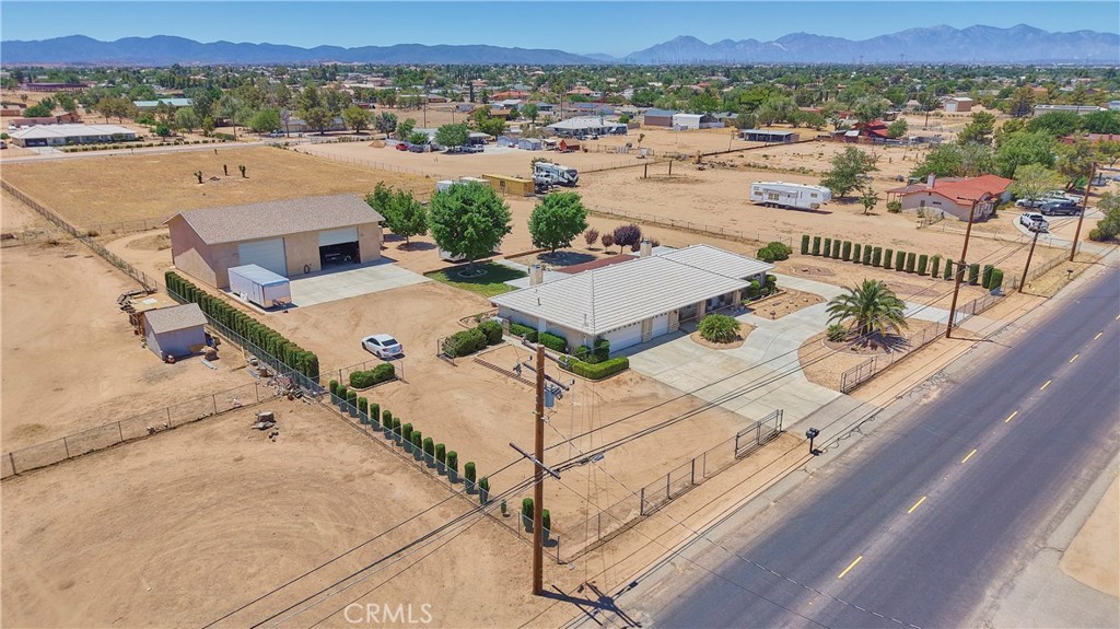 RARE FIND 40X60 PERMITTED STUCCO WORKSHOP + ADU POTENTIAL!
If you're a trucker, mechanic, contractor or investor looking for space and cash flow opportunity - this is the one!
Situated on nearly one and a half acres this workshop has two large roll up doors with side door. Offers 110/220v power, water, interior sink, concrete floor with concrete driveway and low retaining wall. Built-in shelving, workbenches, fluorescent lightning, and full drive-around access. The structure is solid, spacious, and ideal for endless possibilities. There are three drive through gates in front with two drive through gates on each side all large enough for RV entry. Spacious for multiple RV storage inside and outside the workshop.
The beautiful home has four bedrooms, two full bathrooms, open newly remodeled kitchen with kitchen nook, family room, living room with dining room. All in immaculate condition. Three car attached garage, circular and side concrete driveways along with landscaping curb appeal. Located in a quiet area with Mountain views and quick access to the 15 freeway. This property has endless potential for work, living, or cash flow. Don't miss this unique opportunity-schedule your private showing today!