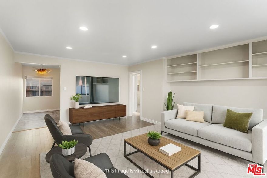 Discover this 2 bed 1 bath ground floor condo tucked inside a classic mid century courtyard community. A private enclosed patio sets the tone, an ideal spot to relax or enjoy a quiet moment outdoors.  Step inside to a bright open living room with recessed lighting, built in shelving, and a large window that fills the space with natural light. The remodeled kitchen blends clean modern finishes with mid century flair, featuring white cabinets, stone countertops, newer appliances, and a sputnik style light above the dining area.  The updated bathroom feels fresh and elegant with a stone top vanity, gold toned hardware, a black arched mirror, and a tiled shower/tub. Both bedrooms offer a minimalist calm aesthetic anchored by a custom floor to ceiling wardrobe system that maximizes storage.  Enjoy in unit laundry, an extra storage closet, a private shed, and one secured subterranean parking space with access from Lamos Street. The complex offers secured entry, landscaped courtyards, and classic mid century design elements throughout.  Located near Inglewood's growing sports (Sofi and Intuit Dome) and entertainment district (Kia Forum), shopping, dining, public transportation, and convenient 405 access to the Westside and Beach Cities.