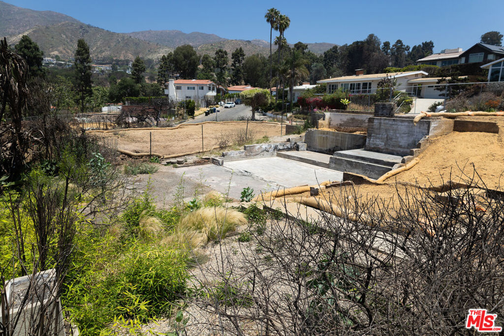 Phase 2 clearance complete. Previously 1589 square foot, 3 beds and 2.0 baths. Views of hills, trees, and peekabo ocean from second floor. Lovely neighborhood and street, many homes in tact all around.