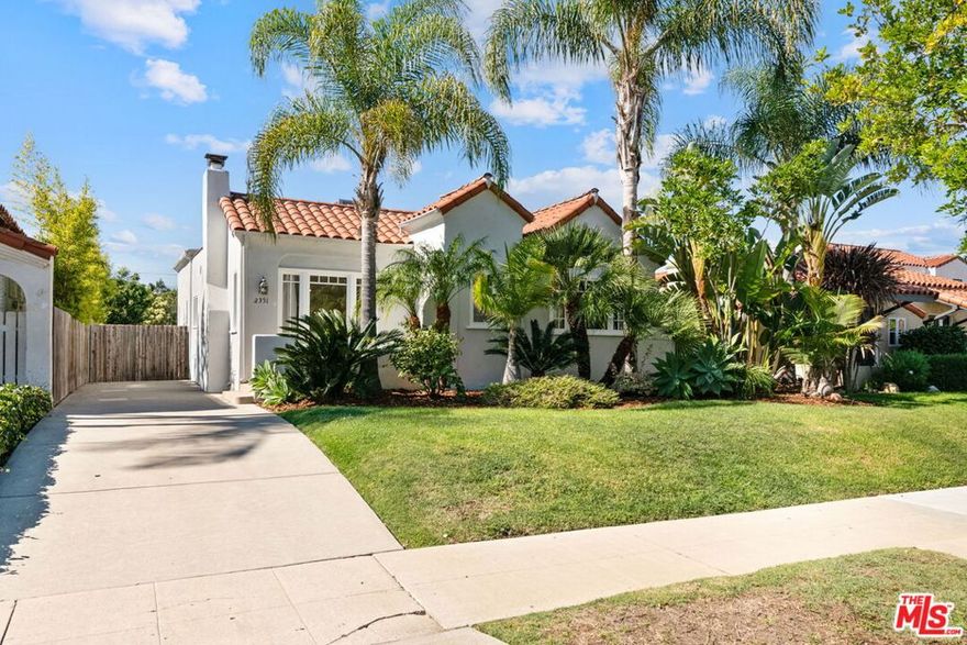 Beautiful 3 bed/2 bath + great room expanded Traditional with the perfect floor plan on a spacious 6,759sf lot. The entry opens to living room with vaulted ceiling, original Batchelder-tiled fireplace and large archway opening to dining room with built-ins and large window overlooking greenery. Spacious kitchen with island and breakfast bar, vintage gas range/oven, tiled countertops and an abundance of cabinetry all opening to family/great room with vaulted ceilings, recessed lighting and French doors to back deck with veranda and grassy backyard, newly hardscape backyard and gated driveway. 2 bedrooms with crown molding and built-out closets and completely remodeled marble-finished full bathroom in hallway and expanded primary suite with French doors to deck and backyard and 2 large closets. Primary bathroom with dual basins and updated tiled shower. Additional features include hardwood and tile flooring, dual-zoned central ac/heat,  garage is partially drywalled and currently used as office/gym.  Close proximity to Pico Blvd. retail and restaurants, Rancho Park golf/park and recreation center, Westfield Century City Mall, UCLA and Beverly Hills. Located in the highly coveted Westwood Charter School District.