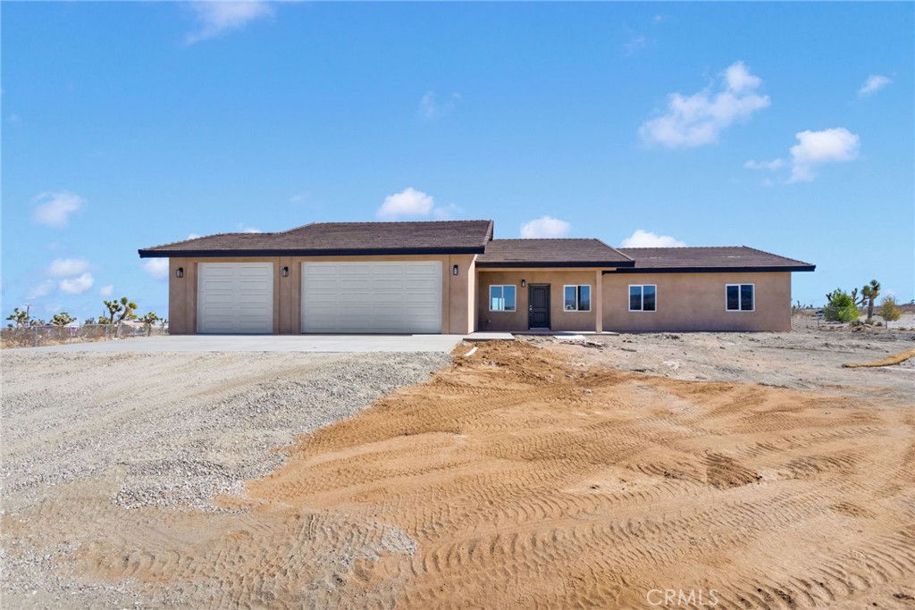 Welcome to your modern desert retreat in Piñon Hills! This brand-new 4-bedroom, 3-bath home offers 2,100 sq. ft. of thoughtfully designed living space on a fully fenced 1.87-acre lot. Ideally located on Rosado Road—less than 300 feet from the paved Duncan Road—this property provides excellent accessibility while maintaining the peaceful, rural charm Piñon Hills is known for.
Step inside to an open-concept layout showcasing beautiful modern color choices and contrasting dark trim for a clean, contemporary look. The interior features luxury vinyl plank flooring in the main living areas and plush carpeting in the bedrooms and walk-in closets. The chef’s kitchen highlights sleek gray cabinetry, custom quartz countertops, and soft-close drawers, carried seamlessly through the bathrooms, laundry room, and hallway. The primary suite includes a spa-inspired bathroom with a custom-tiled shower and a walk-in closet complete with built-in shelving and a shoe rack.
Energy-efficient upgrades include dual-pane windows and sliding doors, a 5-ton HVAC system, solar panels, full Title 24 compliance, and radiant barrier roof insulation for year-round comfort. Stylish farm-style doors and the modern palette throughout add a timeless designer touch.
Additional highlights include an oversized 3-car garage with extra depth, a dedicated laundry room, a covered front porch, and ample space for RV parking, horses, or a future workshop—offering the flexibility to enjoy true desert living.
Located just minutes from Highway 138 and Phelan’s Snowline School District, this property combines quiet country living with convenient access to local shopping, dining, and Wrightwood’s mountain recreation. Don’t miss this exceptional new build in one of the High Desert’s most desirable areas!