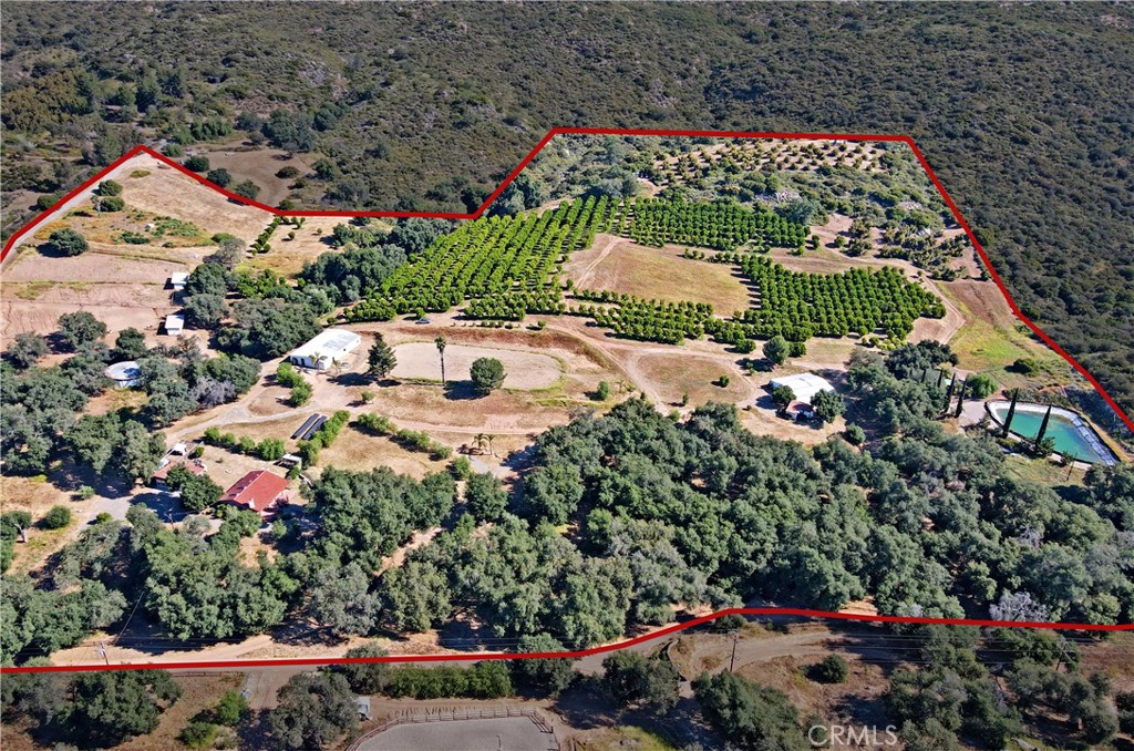 33-acre horse and agricultural ranch in the hills of Escondido with two adobe homes (2 bedroom, 1 bath and 1 bedroom, 1 bath guest house) with their own carved out backyard, a 1 bedroom, 1 bath house, a 3 bedroom, 1 bath manufactured home, and a spacious workshop to store any equipment or vehicles needed to maintain the ranch. The property also has a 2-horse stall, a 12-stall barn, an indoor horse riding carousel, and a large horse riding area. In addition, there's a private well on the ranch powered by solar panels and a large reservoir. There's 5 acres of Valencia oranges and 3 acres of Haas avocados with gravity fed irrigation. Get out of the city and enjoy this beautiful ranch with all its features, especially the views from the top of the property overlooking a lake and other mountains.