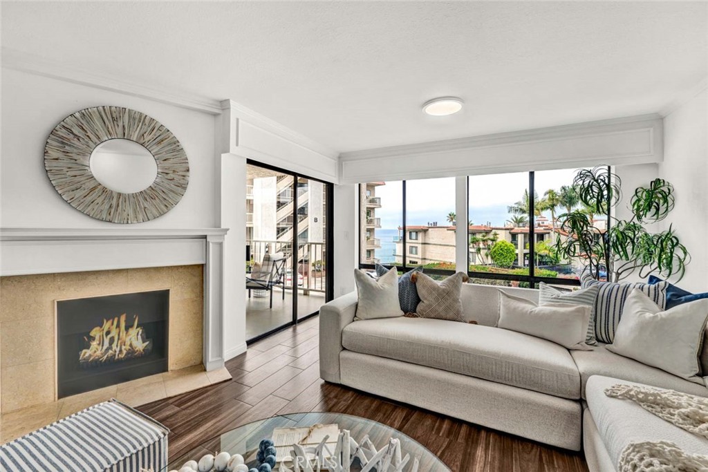 A PRICE IMPROVEMENT too as you step into your COASTAL DREAM HOME you’ve always imagined—where the sound of waves sets the rhythm of your days and the scent of salt air wafts through your windows. Just minutes from the sand, this beautifully updated single-level, first-floor END UNIT in the highly sought-after, Reef Gate West community invites you to embrace RESORT-STYLE living in the heart of San Clemente’s beloved PIER BOWL. The fresh paint, professionally staged interiors, and newly carpeted bedrooms create a crisp, welcoming atmosphere. The light pours into the OPEN-CONCEPT living spaces, where a cozy fireplace anchors the room and the ocean view frames your daily backdrop. Step onto your private covered balcony to watch the breakwater shimmer at sunset, feel the sea breeze on your face, nice.
The home’s thoughtful upgrades shine—two of the three bathrooms have been completely remodeled with custom tile & fixtures, creating spa-like retreats. Both bedrooms are designed for comfort, while the primary suite offers a serene escape at the end of the day. Practical touches like an in-unit washer and dryer make it easy, while crown molding, Tile (but natural wood looking) flooring, and a nice kitchen that opens to the family room make it company and entertaining friendly for sure. The GATED and SECURE Reef Gate West offers every amenity to enhance your coastal lifestyle: two sundecks, a year-round heated pool and spa, fitness center, Sauna, game room, Meeting or Party Room with a full kitchen, plus you will enjoy a PRIVATE gated access to the beach, and on your way down, you will notice a huge dedicated storage area for surfboards and beach gear. You also get a gated secure garage parking area with two spaces and guest parking add peace of mind.
From your home, stroll to the surf and sand in moments, or wander up to the vibrant shops and world-class restaurants of AVENIDA DEL MAR and downtown San Clemente. Whether it’s morning walks on the SAN CLEMENTE PIER, afternoons spent watching whitewater roll in, or evenings gathering with friends on the expansive patio right in front of your unit, overlooking RENOWNED Casa Romantica, this home is more than a residence—it’s a lifestyle. Own a rare piece of paradise where modern comfort meets timeless coastal beauty. Short term rentals are ok (30 days or more) So this is a good investment as well. HOA includes ALL utilities except Electric!