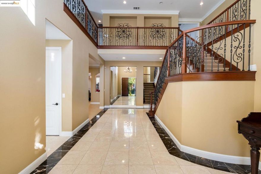 Nestled in the prestigious Stonebrae Country Club community, this immaculate Toll Brothers home blends luxury, comfort, and smart-home convenience. Approx. 4,434 sq ft with 4 bedrooms and 4 baths, this home offers soaring ceilings, grand formal living and dining rooms, and an expansive open-concept family room that flows to a chef’s kitchen with upgraded cabinetry, a waterfall center island, premium appliances, and a large pantry, perfect for everyday living and entertaining. The highly desirable floor plan features a full bedroom and bathroom on the main level, ideal for guests, aging in place, or multi-generational living, plus spacious upstairs bedrooms and a serene primary suite with a private retreat. Recent updates include fresh interior and exterior paint, custom blinds and sheers, designer lighting, and beautifully maintained front landscaping. Additional highlights include a solar energy system, smart thermostats, and an upgraded garage with storage. Located in a 24-hour guarded, gated TPC golf course community with Bay views and Stonebrae Elementary inside the gates, this is Hayward hilltop living at its finest.