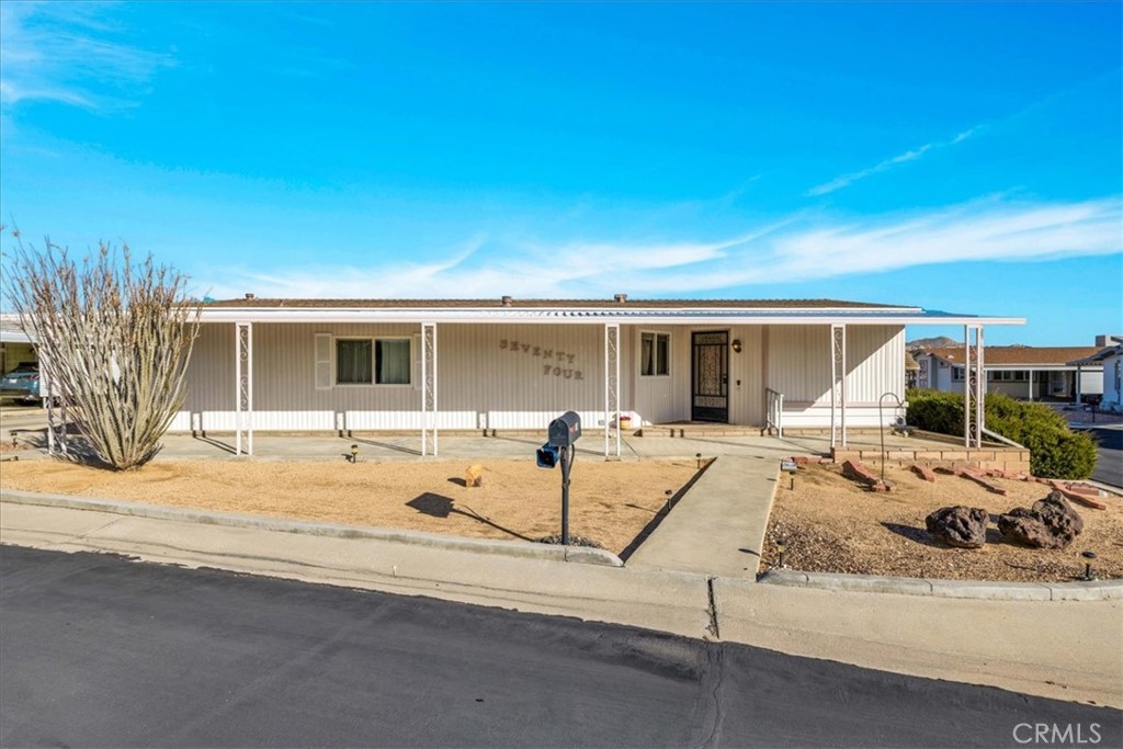 *PRICED TO SELL* Looking for a lovely CORNER LOT property in a great neighborhood complete with a full wrap around driveway!? Look no further! This charming 2 bedroom, 2 bath home features 1,248 sqft of living space and is located in the highly desirable Gates of Spain Mobile Home Park of Yucca Valley. This 55+ community boasts a welcoming atmosphere complete with a community pool and clubhouse, sauna and well maintained grounds. As you arrive, you'll notice the wonderful large covered patios on either side of the home & the beautiful Mountain Views. Inside you'll find a spacious living room which flows effortlessly into the dining and kitchen space complete with ample cabinet/storage space and a picturesque window above the kitchen sink. Both bedrooms feature carpeted floors, ceiling fans, large windows and the primary adorns a generously sized ensuite bathroom with a soaking tub and oversized single sink vanity. It’s worth noting that this home has new(er) double-pane windows & the carpet and linoleum are new(er) (Purchased around 2021). You'll also find a convenient indoor laundry room, an outside storage shed and lovely natural desert landscaping. Come take a look & let this home's charming allure do the rest. Your new desert home awaits!