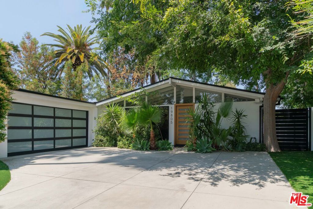 Stunning post & beam mid-century home in Woodland Hills! Built in 1954, this well-maintained single-story home features 4 bedrooms, 2.5 bathrooms, 2,079 square feet of living space, a 7,500+ square foot lot and a 2-car garage with direct access. The home features a renovated kitchen with contemporary finishes, matte black hardware, soft-close drawers, stainless steel appliances and pendant lighting, a fireplace in the family room, interlocking wood-like laminate flooring throughout the entire house, a spacious dining area, a large open living room, lots of natural light and high ceilings. All three bathrooms are recently renovated with new tile, vanity, sliding shower door, frosted low-e glass, and black matte finishes. This beautiful home also features a new vinyl fence and side gates, new artificial turf, newer rain gutters, a 10-camera Ring alarm system, a newer garage door and front door, dual pane windows, newer window treatments, a freshly painted exterior, two new patio decks made of weather treated and termite-resistant materials, smart thermostat and many other custom details. The backyard also has fruit-producing grapefruit, orange, kumquat and fig trees. Only a 5 minute drive to the Westfield shopping center or the 101 freeway! Video link: https://drive.google.com/file/d/10NbimrlpgON_MGrD_cdKK5-5-5XtuCVr/view?pli=1