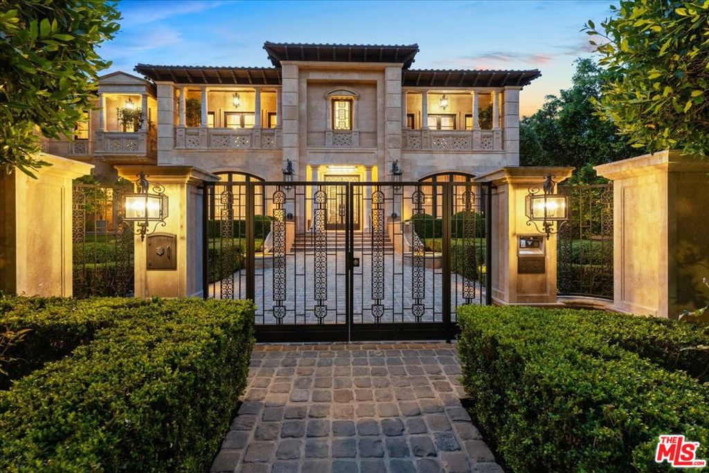 A triumph of design, craftsmanship, and grandeur, 804 N. Elm Drive is an extraordinary approx. 20,000-square-foot Italian-style limestone villa nestled in the heart of the prime Beverly Hills Flats. Created by a powerhouse team of Los Angeles design iconsarchitect Richard Landry, builder John Finton, interior designer Joan Behnke, and landscape designer Christine Londonthis 7-bedroom, 15-bathroom estate was the recipient of Robb Report's Ultimate Home Award and stands as a true modern classic. Completed in 2011, the home is crafted entirely from hand-carved Dijon limestone, with a west-facing faade that fuses classical Italian elegance with Art Deco sophistication. The interiors are a symphony of curated detail, from a soaring foyer with a 7-foot bronze chandelier and Dale Chihuly glass sculptures, to panel-lined corridors illuminated by silk runners and vintage light fixtures. Every space has been designed for both intimate living and large-scale entertaining. The grand living room features custom architectural details and opens seamlessly to a stone-paved loggia through accordion doors, allowing for effortless indoor-outdoor flow. A 1,000-gallon saltwater aquarium, a two-story groin-vaulted gallery terrace, and a theater with a hand-crafted mahogany ceiling enrich the estate's immersive ambiance. The formal dining room overlooks the front garden and features custom millwork and bespoke lighting. The kitchen, designed to accommodate multiple preparation areas, is equipped with a stainless-steel barrel-vaulted ceiling, kosher Italian granite countertops, and hand-built mahogany cabinetry. A spacious breakfast room opens to the garden, pool, and water features, emphasizing the home's seamless connection between indoor comfort and outdoor beauty. The primary suite is a private sanctuary with vaulted ceilings, French doors to a trellised terrace, dual master baths, and a flexible sitting area that can be closed off with a large pocket door. One primary bathroom features a scalloped ceiling, custom mosaic floors, and a glowing skylight, while the second primary bathroom is clad in rich wood and Italian marble with bespoke bronze fixtures. Below ground, the lower level includes a nautically inspired game room, a full spa with an Endless pool, hot tub, steam room, massage area, and a professional-grade home theater. These amenities provide space for both recreation and relaxation, all finished to the highest standards. The exterior continues the home's architectural brilliance with a limestone rear faade enhanced by classic columns, arched openings, and carved roof details. The landscaping reflects a Northern Italian palette, transitioning from formal clipped boxwood and citrus trees at the front to lush, informal plantings and potted greenery surrounding the pool and entertaining areas in the rear. A pergola with a partial outdoor kitchen and grill completes the backyard retreat. A separate stone-clad guest pavilion offers privacy and rustic charm, positioned as a counterpoint to the elegance of the main residence. 804 N. Elm Drive is a rare achievement in architectural vision, blending classical European inspiration with California luxury living in one of Beverly Hills' most coveted locations.