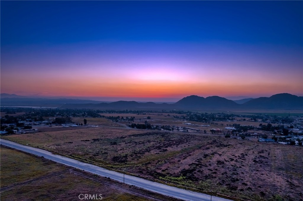 Perfect lot for a family compound! 0 Montgomery Ave, lot SVOL 10 is 5.62 acre parcel sits on a paved road in the heart of Nuevo, with potential for a lot split (subject to county approval). The property is mostly flat with some gentle slope, providing excellent opportunities for residential development. Enjoy stunning mountain views and plenty of space to build your custom home or place a manufactured home (permitted). It’s also ideal for horse property.The seller completed percolation tests years ago for much of the subdivision. The property will require a septic system and well. The lot has not been surveyed, and the images provided give an approximate location. Additional adjacent parcels are available for sale, each sold separately. Property does not have a current address, use map to find location. Seller financing available with a 35% down payment, an 8% interest rate, and a 2-year term.