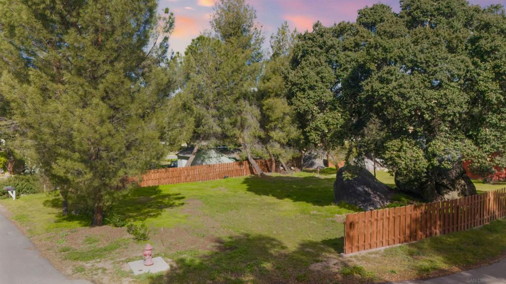 Seller will consider offering seller financing with the following terms, 6.25% interest rate, 10-year fully-amortized loan with 20% down. Excellent lot located in Lake Morena Village with a lake view. Level, corner, 1/3 acre, partially fenced parcel located in a beautiful neighborhood with friendly neighbors. Septic percolation test passed and septic layout plan for Supplemental Treatment System approved. Site plan for a 1 bedroom + Den manufactured home approved. 3/4” water meter installed. Existing power pole is adjacent to the lot and most permits for finishing your dream home have been paid. Only a 1 hour drive to Downtown San Diego, 1 block from public transit, 1 block away from Pacific Crest Trail and County Park and just a few miles from schools and museums. Boulder outcroppings, mature oak trees, and tall pines on the perimeter provide beauty, value and privacy. 120 s.f. wood shed w/ loft and concrete pad included.