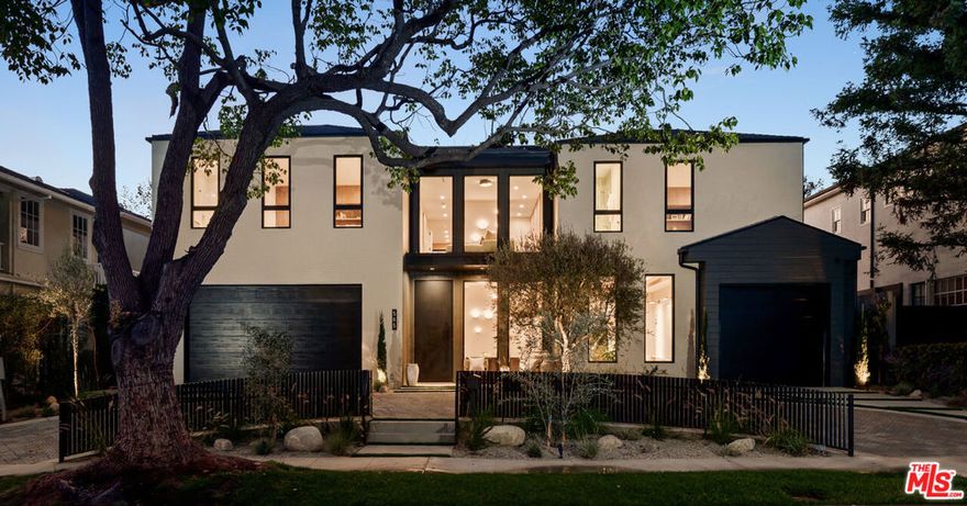 Discover refined coastal living in this newly built architectural estate in the coveted Huntington Palisades. This three-level modern masterpiece offers 7 bedrooms, 9 bathrooms, and over 8,000 sq ft of thoughtfully designed living space, blending timeless materials with cutting-edge convenience. A signature design element is the home's intentional progression of rich walnut and warm oak: bold walnut millwork anchors the main level, while the upper and lower floors transition to softly grained oak, creating a cohesive, elevated aesthetic throughout. Limewash and Roman clay walls, soaring ceilings, and expansive openings set a warm, sophisticated tone from the moment you enter. Custom walnut and white oak cabinetry and paneling, paired with a modern mix of porcelain and glazed ceramic tile, further elevate the home's refined material palette. The custom chef's kitchen is the heart of the home, featuring a Sub-Zero/Wolf gourmet suite of appliances, bespoke cabinetry, an oversized island, and Taj Mahal stone slabs. An extra-large pantry with concealed secondary appliances supports seamless entertaining. The kitchen flows directly into the grand dining area and expansive family room, where a sleek travertine-clad fireplace and oversized sliding doors open to the pool, spa, and outdoor lounge for true indoor/outdoor living. The lower level is designed for entertaining and wellness, showcasing a private movie theater, an Emperador marble clad built-in bar, and a fully equipped gym with steam room. Large sliding doors extend this level to an additional outdoor area, creating a resort-like experience. Plumbing fixtures throughout include selections from Brizo, Watermark, Gessi, Toto, and Mr. Steam, blending function with luxurious craftsmanship.Upstairs, generously scaled bedroom suites provide comfort and privacy, each with curated finishes and luxurious bathrooms. The serene primary retreat offers a spa-like bath and custom wardrobe, completing the sense of everyday escape. Additional amenities include an elevator serving all three levels, a 3-car garage, and smart-home integrations. The grounds are anchored by an extraordinary 150-year-old heritage tree, a rare natural centerpiece that adds history and character to this modern residence.A rare opportunity to own a meticulously crafted new-construction home in one of Pacific Palisades' most desirable neighborhoods, designed for both grand entertaining and effortless everyday living.